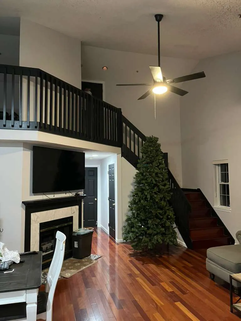 Vaulted living room, stairs and railing finished in black