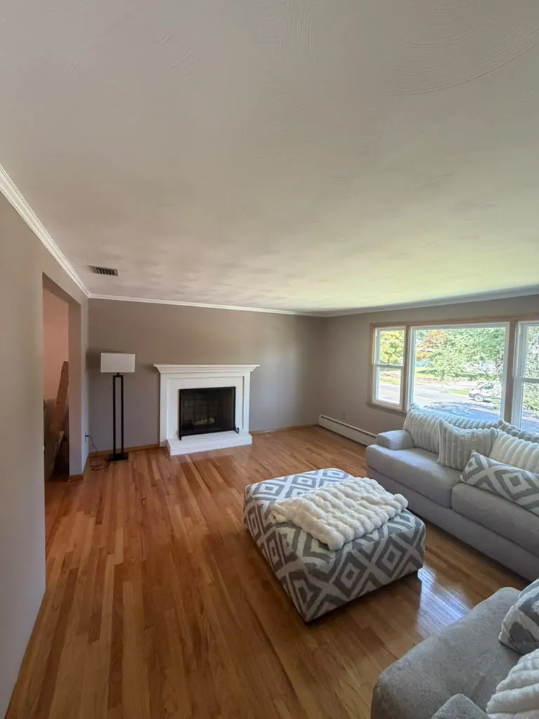 Open living area, smooth walls and clean crown molding