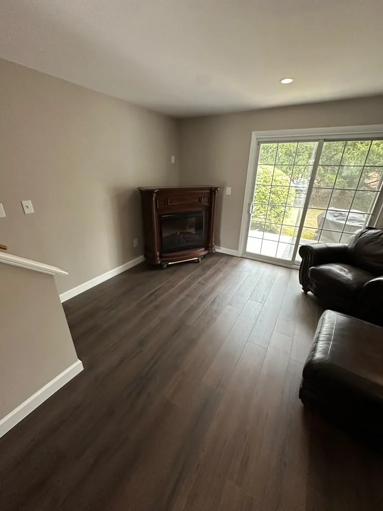 Family room in warm greige with bright white baseboards