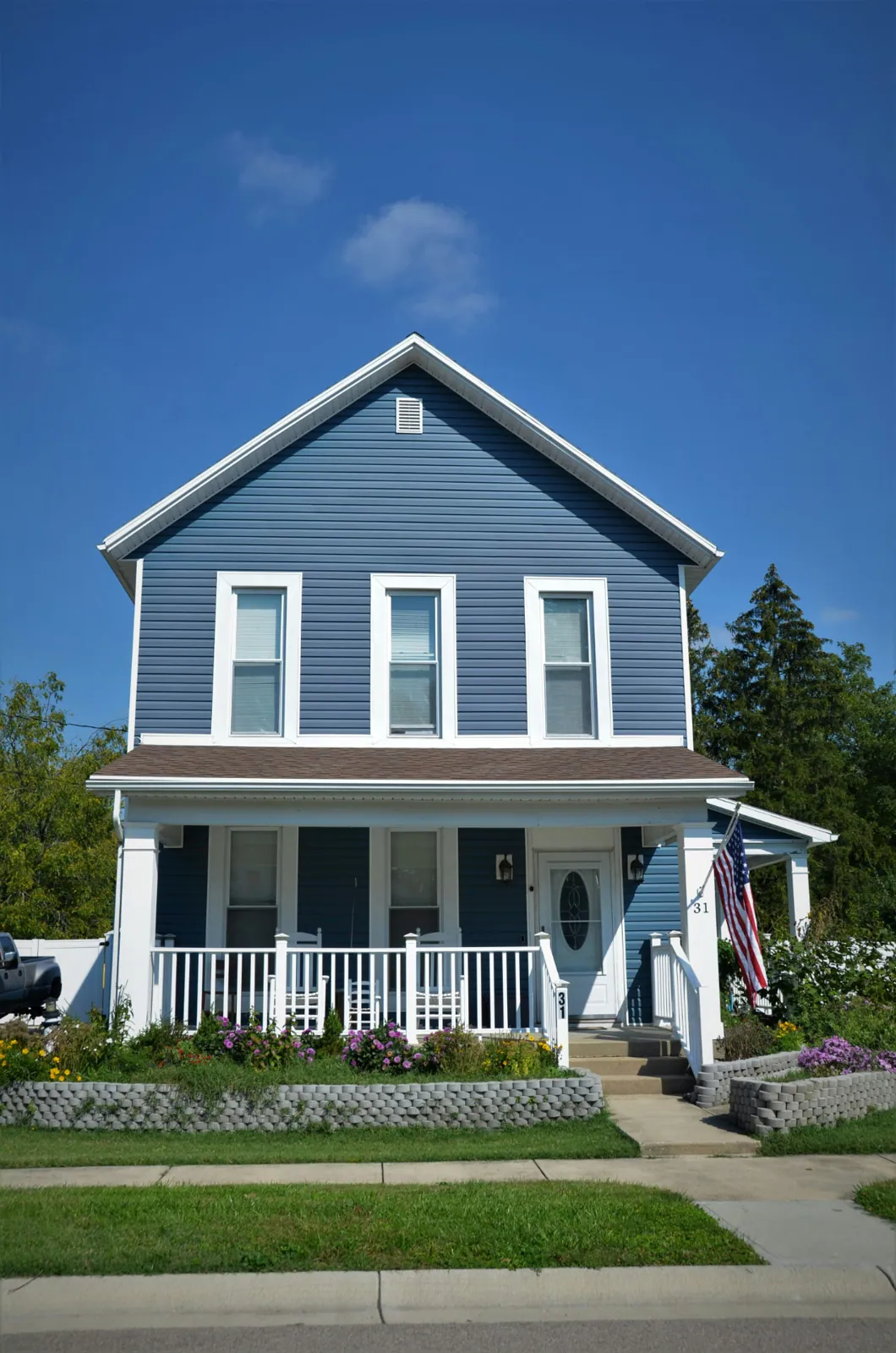 Two-story exterior in deep blue with white trim